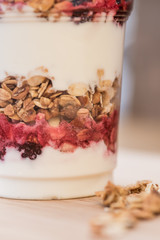 yogurt withgranola and fresh berries in glass