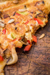 Omelet with vegetables on wood texture