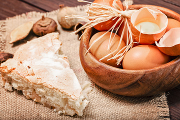 Eggs and pie on a sacking. One egg is broken, rural style, a close up