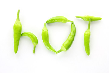 Green chilli peppers arranged to spell the word hot