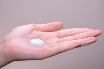 Beautiful young woman hands with cream