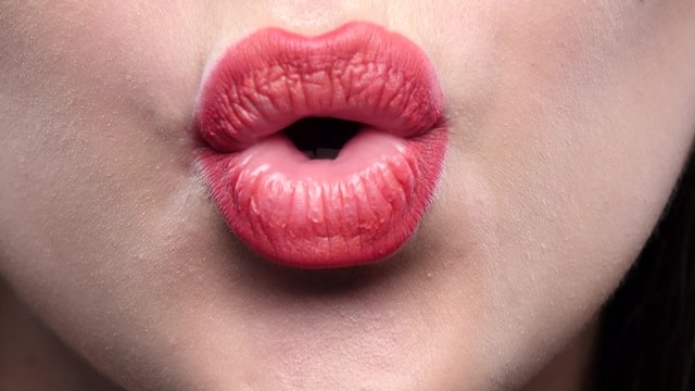 Beautiful sexy red lips giving kiss. Closeup
