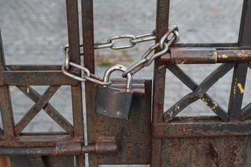 Lock and chain on an old rusty gate