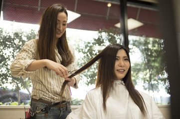 Long hair of women have hair cut in beauty salon