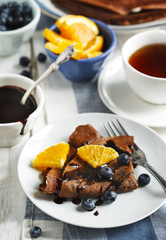 Chocolate crepes with blueberries and orange