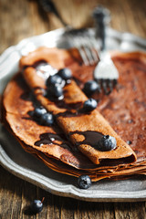 Chocolate crepes with blueberries and chocolate sauce