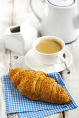 Fresh croissants and cup of coffee
