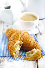 Fresh croissants and cup of coffee
