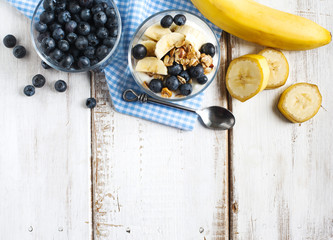 Yogurt with homemade granola, banana and blueberries. Healthy br
