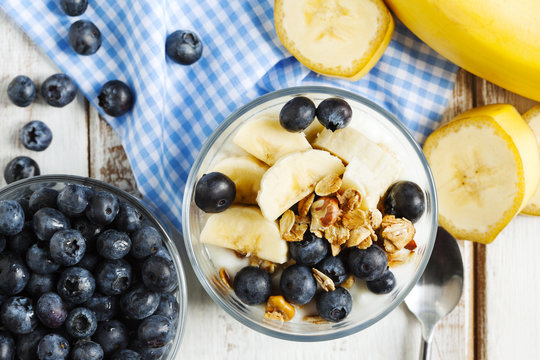 Yogurt with homemade granola, banana and blueberries. Healthy br