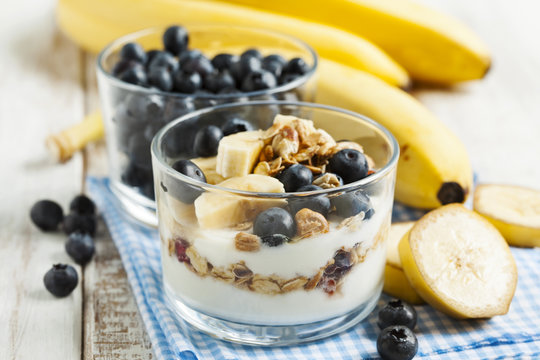 Yogurt with homemade granola, banana and blueberries. Healthy br
