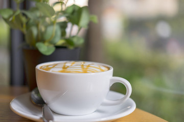 cup of cappuccino over wooden table