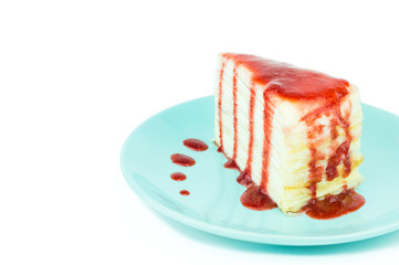 Mille crepe cake with strawberry sauce on white background with