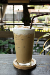 Ice coffee cappuccino on a wooden table