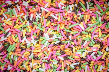 Fototapeta na wymiar colorful rainbow sweet candies spreading pastry decoration backg