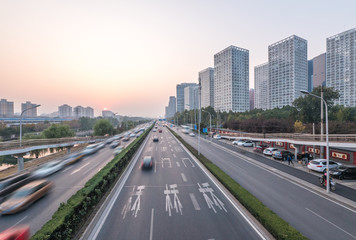 Fototapeta na wymiar traffic on road and modern buildings in beijing