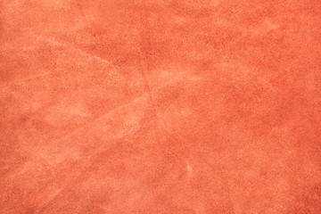 Close up orange color crumpled suede leather texture background