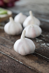 Fresh garlic on wooden background