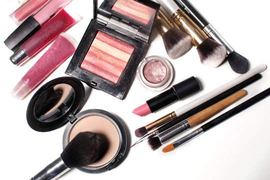 cosmetics, brush , eye shadow , mascara , lipstick , gloss , powder, eyeliner on an isolated white background