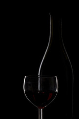 Bottle of wine and a glass of wine on a black background, minima