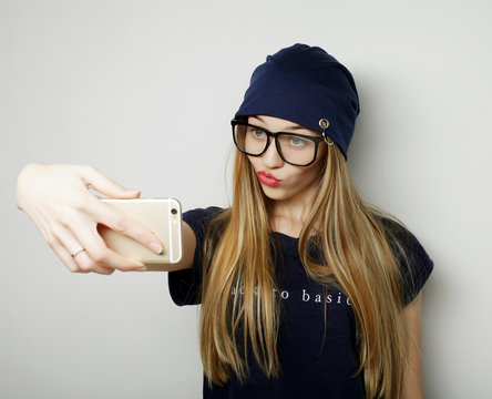 Pretty hipster girl taking selfie. 