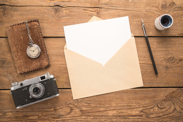 Different objects and envelope on a wooden table 