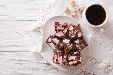 Chocolate cake Rocky road and coffee on the table. horizontal top view 
