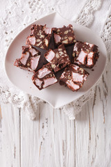 Chocolate cake Rocky road close-up on the table. vertical top view
