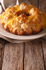 Homemade monkey bread with cheese on a plate. Vertical
