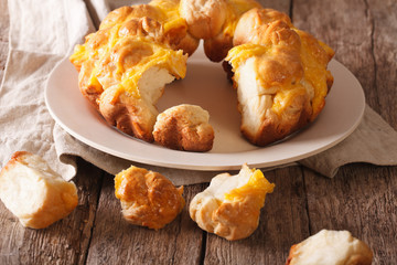 Cut monkey bread with cheese close-up on a plate. Horizontal
