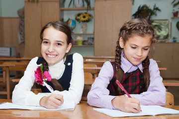 happy schoolgirl writing
