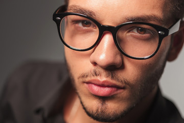 closeup portrait of a young cute man with glasses