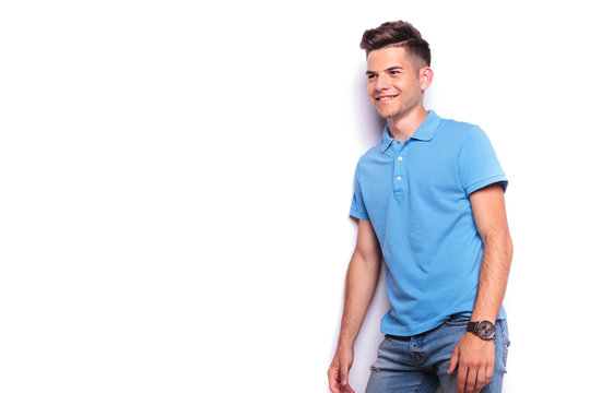 side portrait of man in polo shirt and jeans