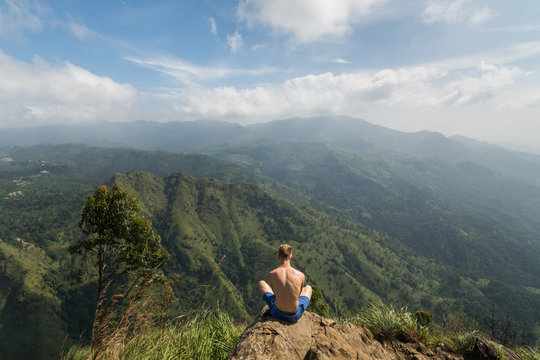 Man Sitting on the Peak of Ella's Rock Overlooking the Valley, Sri Lanka