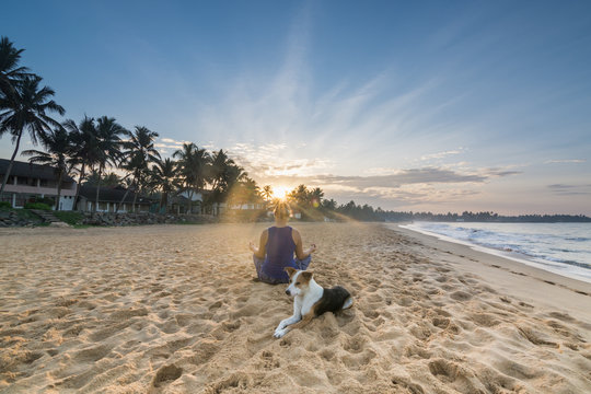 Young Woman Practicing Yoga At The Beach During Sunrise In Hikkaduwa, Sri Lanka