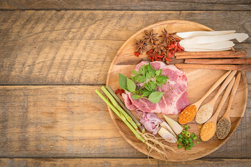 Meat with Herbs, Spices and Veggies on  Wooden Rustic Table, top