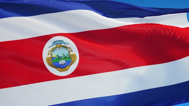 Costa Rica flag waving in slow motion against clean blue sky, seamlessly looped, close up, isolated on alpha channel with black and white luminance matte, perfect for film, news, digital composition
