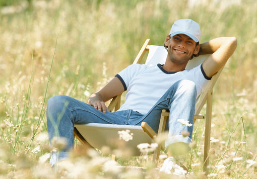 Man reclining on deck chair