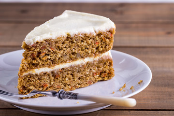 A slice of carrot cake on a white plate