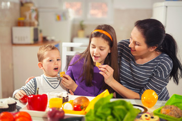 Mother making breakfast for her children in the morning at home