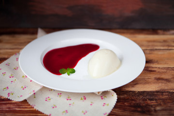 Panna cotta with Raspberry Sauce, Italian dessert on wood backgr