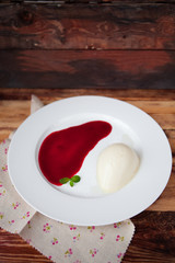 Panna cotta with Raspberry Sauce, Italian dessert on wood backgr