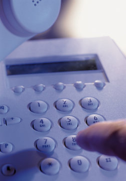 Person dialling a telephone