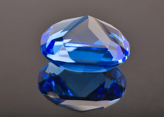 blue sapphire with reflection on brown