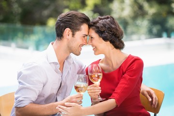 Romantic couple holding white wine 