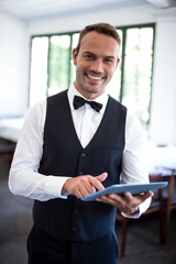 Fototapeta premium Waiter using digital tablet