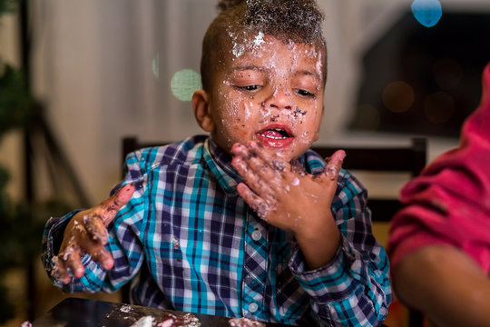 Kid with cake-covered face. 
