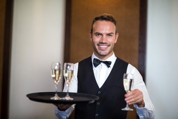 Handsome barman serving champagne