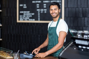 Pretty barista using cash register