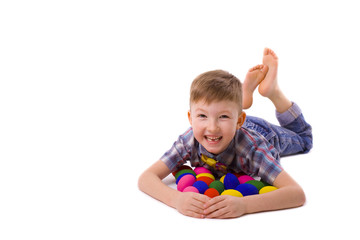 boy of five years with easter eggs lying on the floor